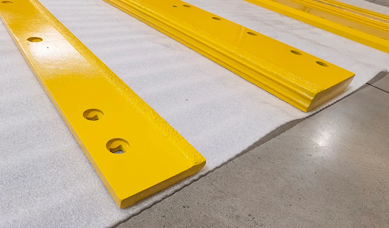 Row of tungsten carbide inserts welded along a snow plow cutting edge