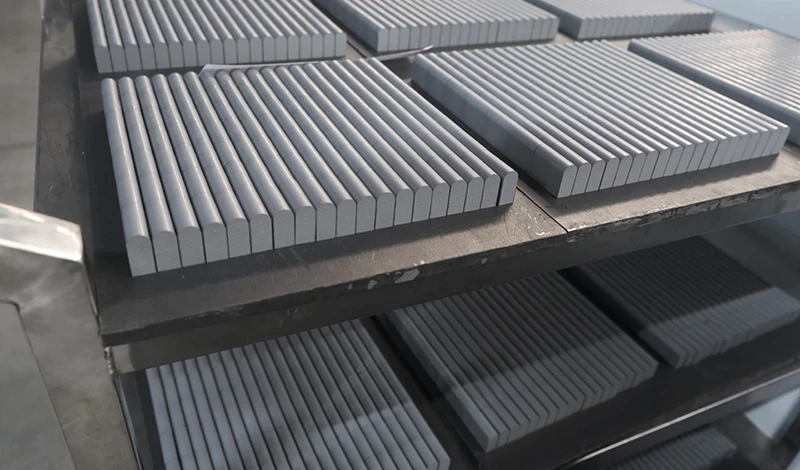 Carbide inserts laid out to show spacing and density along the edge