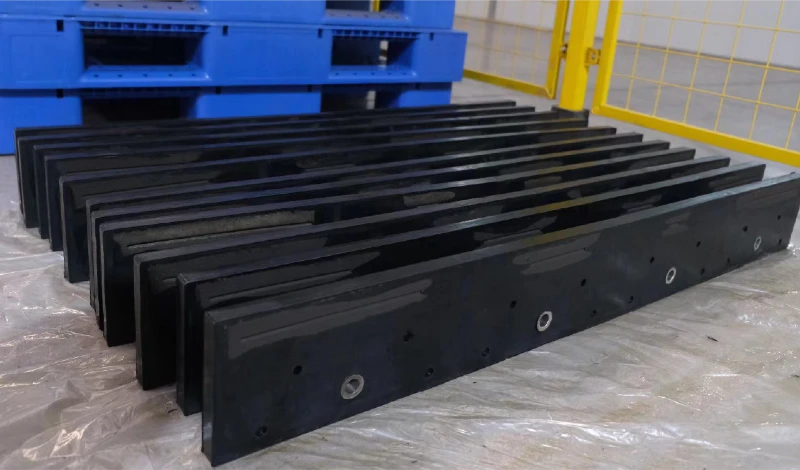 Packaged JOMA style snow plow blades prepared for export shipping